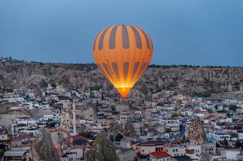 Goreme, Cappadocia. Turkey. October 14th 2018. A hot air balloon flies over the Anatolian village