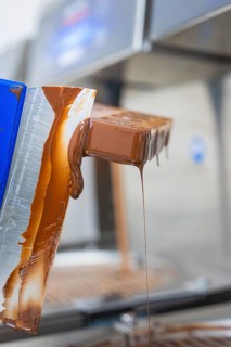 Flowing chocolate from a chocolate mold, vegan chocolates production, Haselstaller Hof, Gechingen,