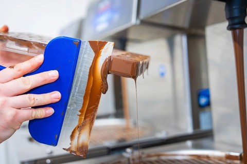 Side view of a flowing chocolate mold, vegan chocolates production, Haselstaller Hof, Gechingen,