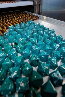 Blue prismatic chocolates with shiny surface in a bakery, Easter production of regional products,