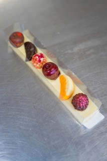 Various chocolates in a transparent gift box on a metal surface, Easter production of regional