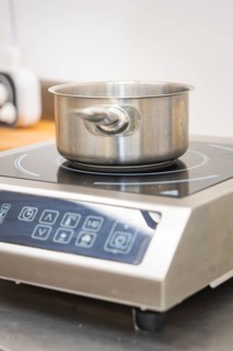 Stainless steel pot on an inductive hotplate in the kitchen, vegan cake production, Haselstaller