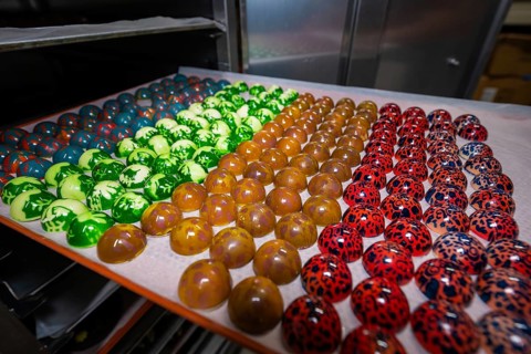 Different colored chocolates arranged on a tray, Easter production of regional products,