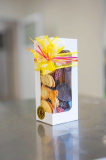 Elegant gift box decorated with chocolates and a yellow bow, Easter production of regional