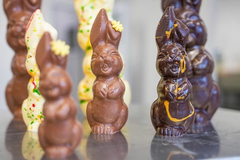 Various chocolate Easter bunnies in an Easter mood, Easter production of regional products,
