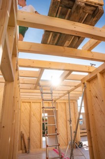 Interior view of a timber structure with ladder and sunlight, timber house construction, Gechingen,