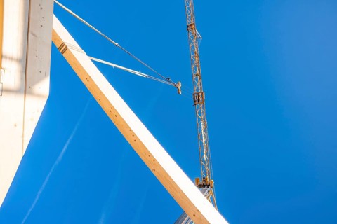 Construction elements in the foreground with a large crane, timber house construction, Gechingen,