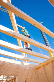Construction of a wooden building with workers on the roof, timber house construction, Gechingen,
