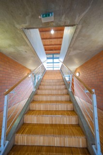 Wooden steps lead up into an open, bright room, Schlehengäu Sporthalle Gechingen, Calw district,