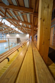 Elongated stand in a gym with participants doing sports activities, Schlehengäu Sporthalle