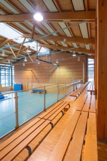 Interior of a gym with long benches and natural light, Schlehengäu Sporthalle Gechingen, Calw