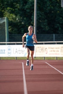 Woman running fast on a track during training, middle distance runner Katharina Jaiser, Gechingen,