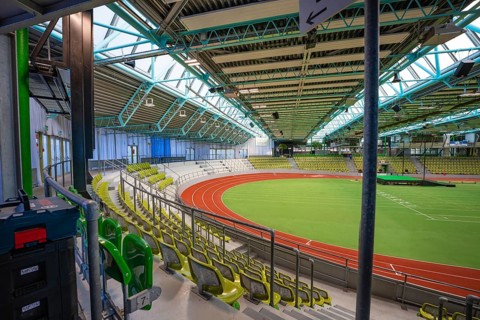 Interior view of an empty stadium with stands and a running track. Spacious atmosphere, middle