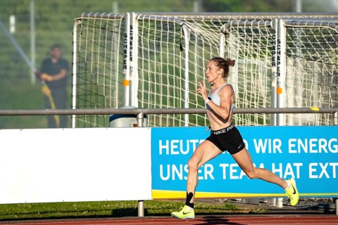 Woman running fast and dynamically on a sports track, middle distance runner Katharina Jaiser,