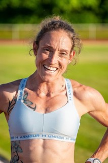 Close-up of laughing woman in sportswear with tattoos, middle distance runner Katharina Jaiser,