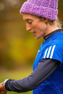Close-up of a woman wearing sporty clothes, in an autumn setting, middle distance runner Katharina
