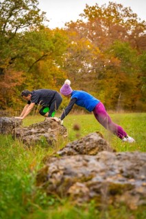 Two people training over rocks in an autumnal landscape, middle distance runner Katharina Jaiser,