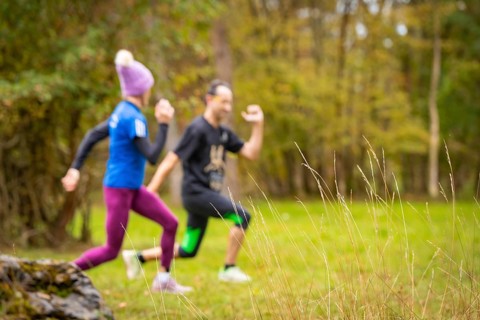 Two people running through an autumnal landscape, middle distance runner Katharina Jaiser,