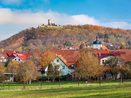 The ruins of Mühlburg and the village of Mühlberg in autumn, Burgenensemble Drei Gleichen,