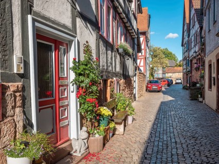 Narrow alley with half-timbered houses and cobblestones in the historic old town of Büdingen,