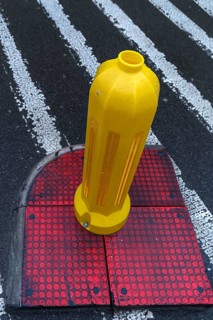 Yellow bollard at a crosswalk, Krakow, Poland