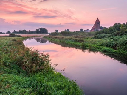 Tribsee with St. Thomas church on the river Trebel at dawn, North German brick Gothic, Peenetal