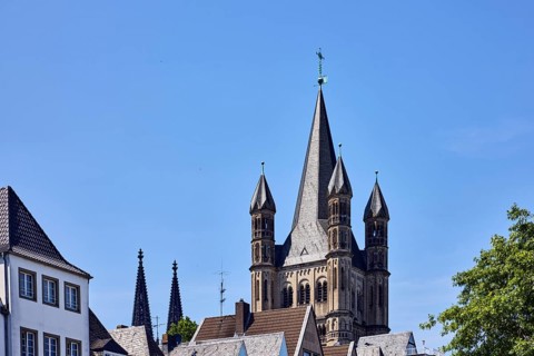 Church spire, steeples of Cologne Cathedral and Great St. Martin, gables, pointed roofs, trees,
