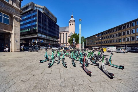 Traffic problem parked e-scooters in the city, general architecture, commercial building, modern