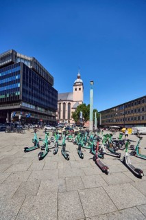 Traffic problem parked e-scooters in the city, general architecture, commercial building, modern