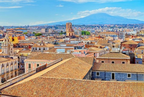 Elevated view of the town with Etna volcano in the distance, Catania, Sicily, Italy