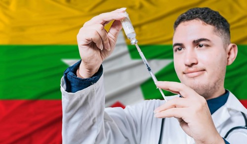 Doctor holding syringe on Myanmar flag background. Medical professional holding syringe with
