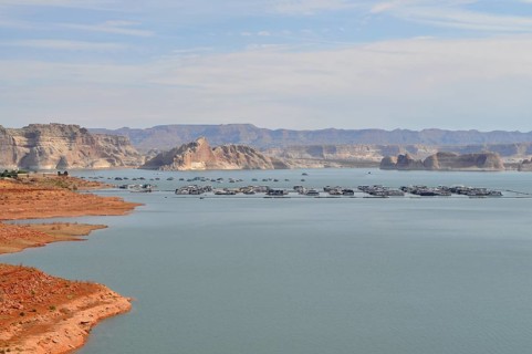 Peaceful water area of Lake Powell with floating houseboats and mountain scenery, Arizona, USA