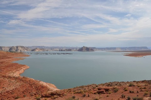 Large, quiet lake surrounded by dry, sandy landscape and hills, Lake Powell, Arizona, USA