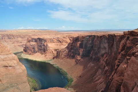 Red rock edges and a flowing river in the middle of the vast desert landscape, Horseshoe Bend,