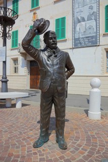 Italy, village of Brescello, the town hall, known from Don Camillo and Peppone, with a bronze