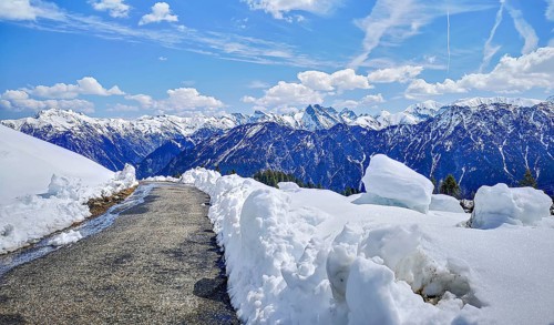 Alpine mountain landscape, hiking trail on the Fellhorn surrounded by snow with panoramic views of