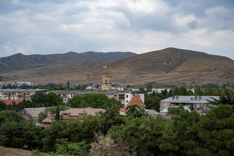 Gori, Georgia. September 9th 2025. Panoramic landscape view with the Georgian flag flying from the