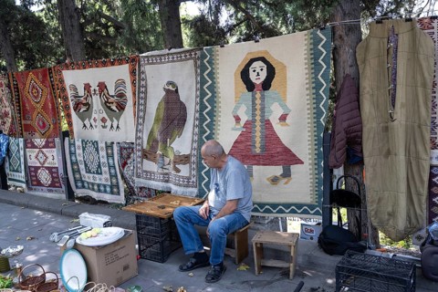 Tbilisi, Georgia. July 11th 2025. Street stall vendor at the Dry Bridge Flea Market selling