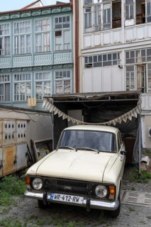 Tbilisi, Georgia. July 7th 2025. An old Eastern European car parked outside some traditional