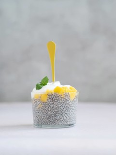 Chia seed pudding with mango and yogurt topped with mint, ready for eating