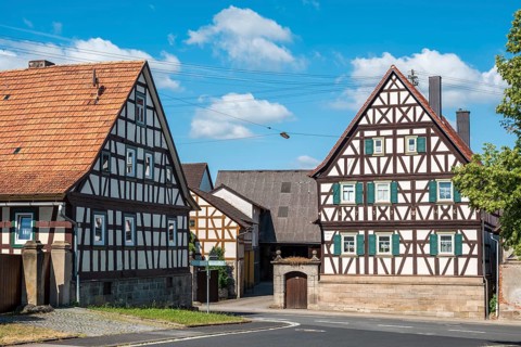 Farms with typical Franconian half-timbered houses in the village of Serrfeld, Sulzdorf an der