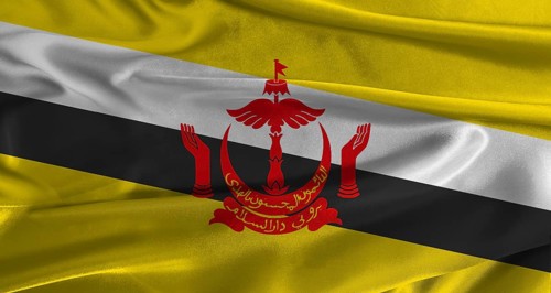 Flag of Brunei with fabric textured background. Close up of National flag of Brunei with realistic