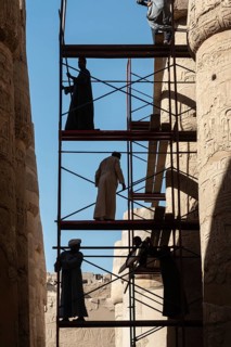 Luxor, Egypt. December 12th 2022 Silhouetted local Egyptian workers cleaning and restoring the