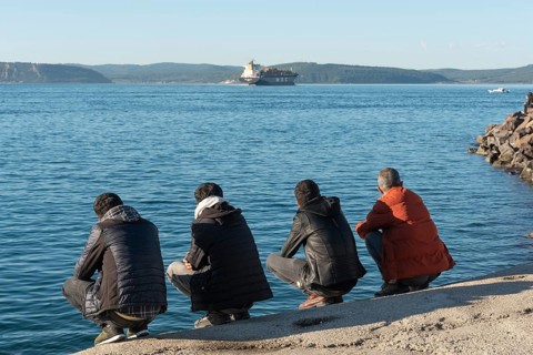 Canakkale, Turkey. February 18th 2022 Turkish men squatting beside the Dardanelles Straight