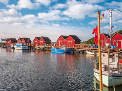 Small red huts and fishing boats in Boltenhagen fishing port, Baltic resort Boltenhagen,