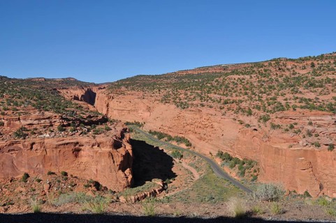 Road runs through a valley with impressive red rocks, Grand Staircase Escalante National Monument,