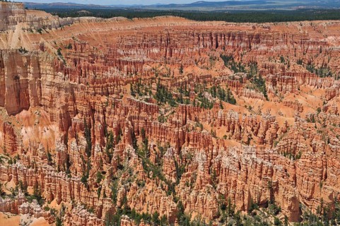 A spectacular view of a vast red rock landscape with numerous gorges and canyons, Bryce Canyon