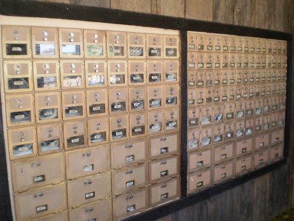 Interior view of many mailboxes in a post office building with wooden surroundings, Henrieville