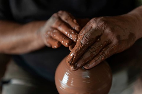 Potter at work making traditional local clay pottery in the Turkish town of Avanos on the river