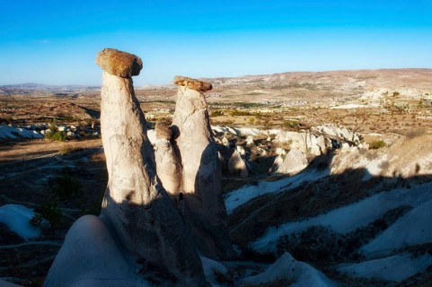 Soft morning light on the fairy chimney rock formations known as the Three Graces, part of the
